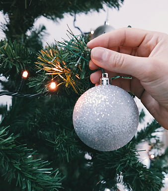 Hand Hanging Silver Glitter Christmas Ornament on Tree