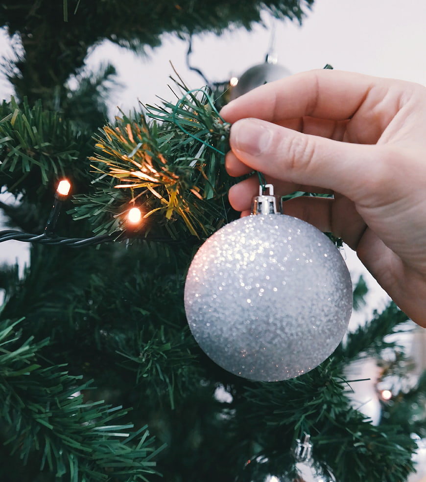 Hand Hanging Silver Glitter Christmas Ornament on Tree