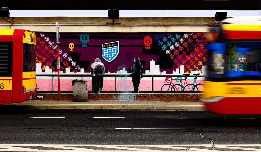 Motion Blur Bus Passing Vibrant Street Art Mural