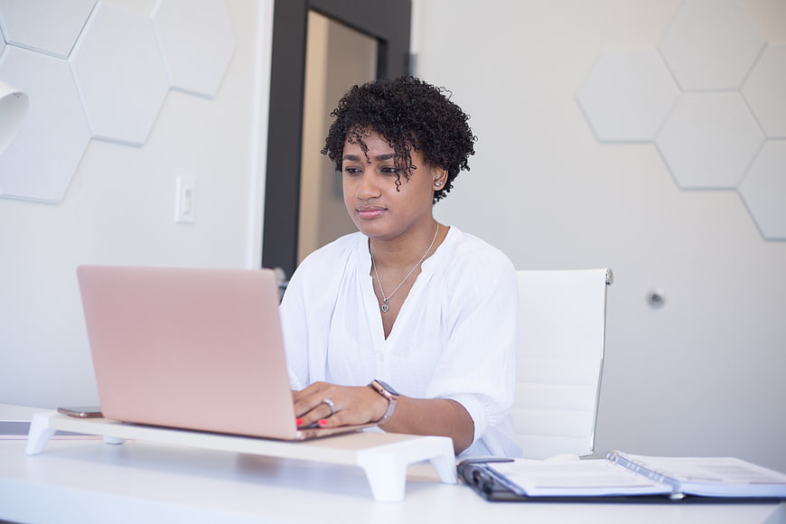 Focused African American Woman Working on Laptop in Modern Office