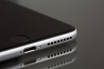 Close-up of Smartphone Bottom Edge with Lightning Port and Speaker Grille