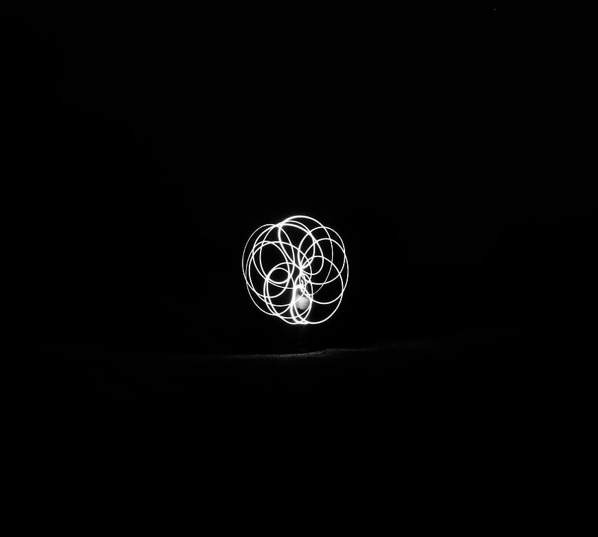 Abstract white light painting sphere on black background