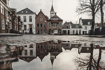 Low angle reflection of Dutch canal houses in puddle