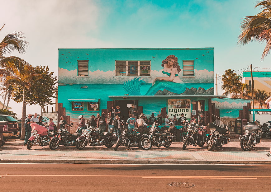Mermaid Mural on Turquoise Building with Motorcycles