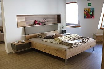 Modern wooden bed frame in minimalist bedroom interior design