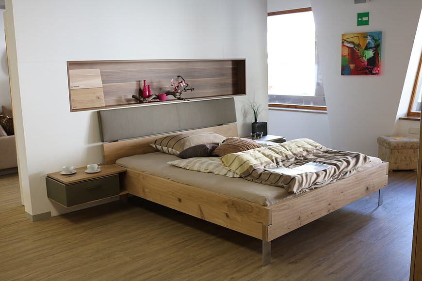Modern wooden bed frame in minimalist bedroom interior design