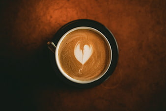 Top View of Cappuccino with Heart Latte Art on Wooden Table
