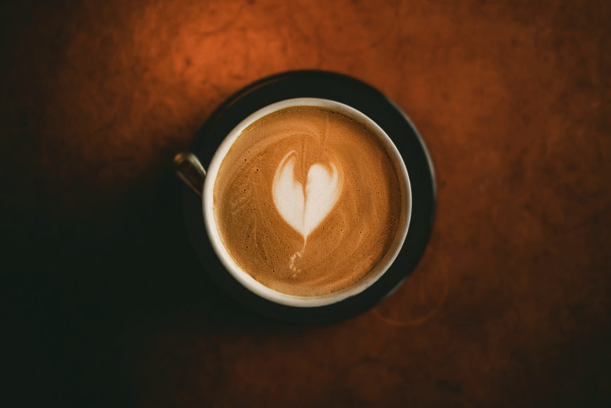 Top View of Cappuccino with Heart Latte Art on Wooden Table