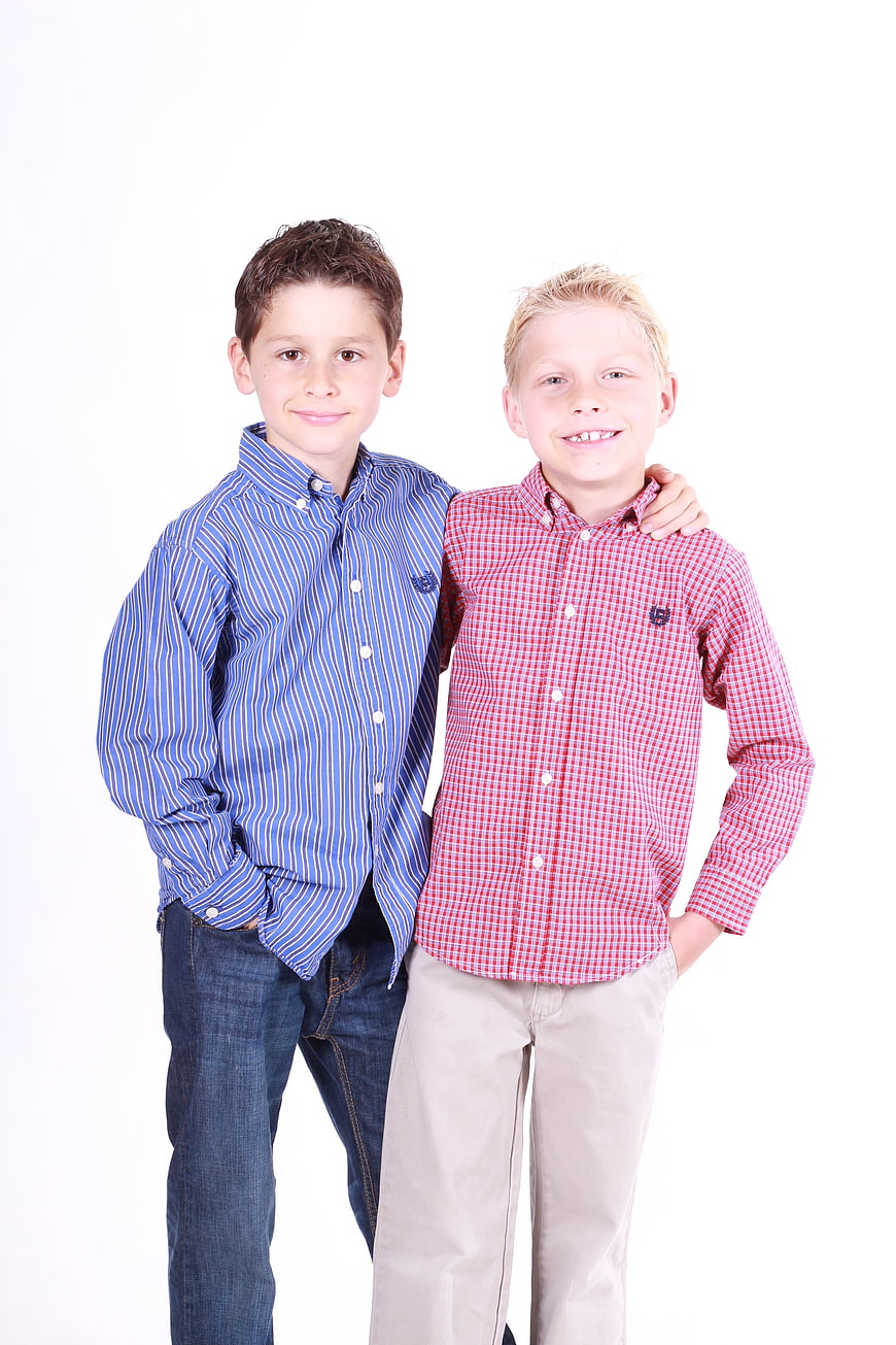 Portrait of two young boys standing together in shirts