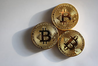 Three Gold Bitcoin Coins On White Background