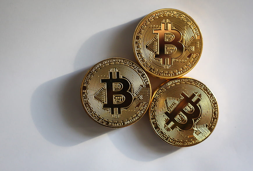 Three Gold Bitcoin Coins On White Background