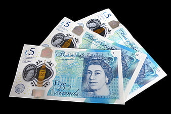 Three British Five Pound Notes on Black Background