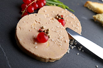 Foie gras terrine with red currants and coarse salt on slate