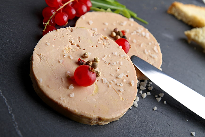 Foie gras terrine with red currants and coarse salt on slate