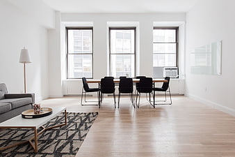 Modern minimalist apartment interior with dining table and large windows