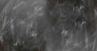 Dark textured chalkboard background with chalk smears