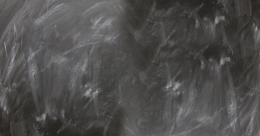Dark textured chalkboard background with chalk smears