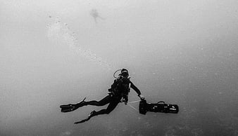Underwater Scuba Diver with Camera Equipment in Black and White