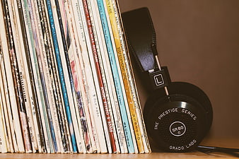 Vintage Vinyl Records and Black Headphones on Shelf