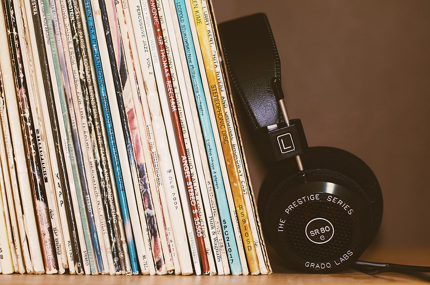 Vintage Vinyl Records and Black Headphones on Shelf