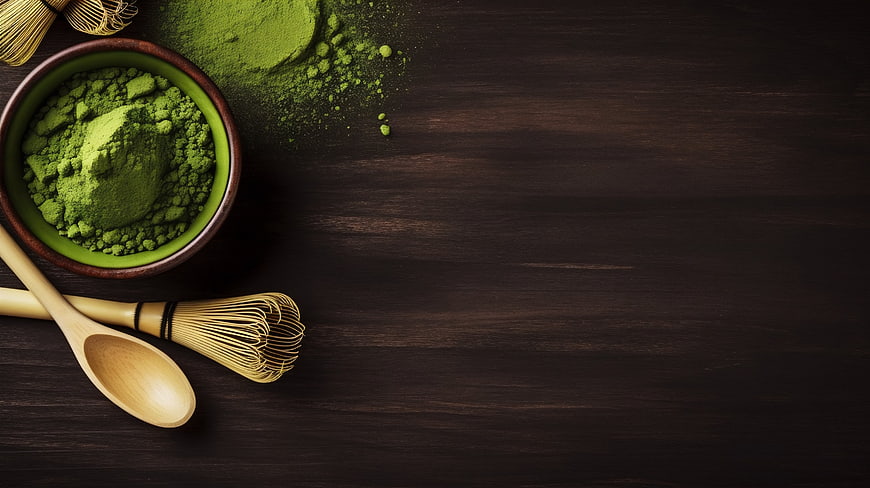 Matcha Green Tea Powder with Bamboo Whisk on Dark Wood
