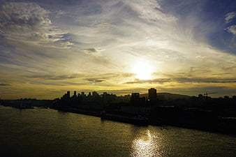 Montreal skyline silhouette at golden hour over the river