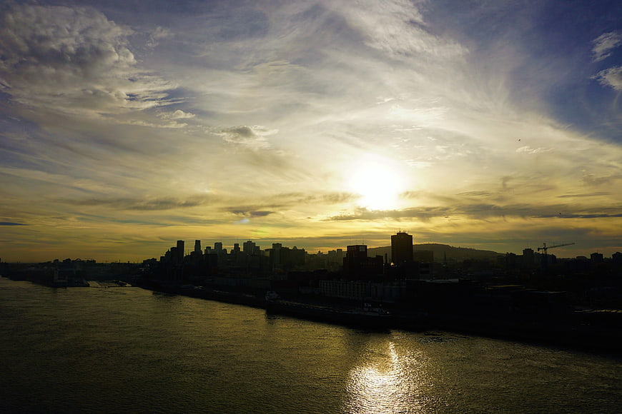 Montreal skyline silhouette at golden hour over the river