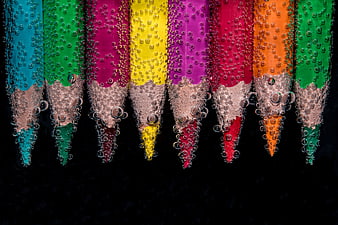 Colorful Pencils Submerged in Water with Bubbles