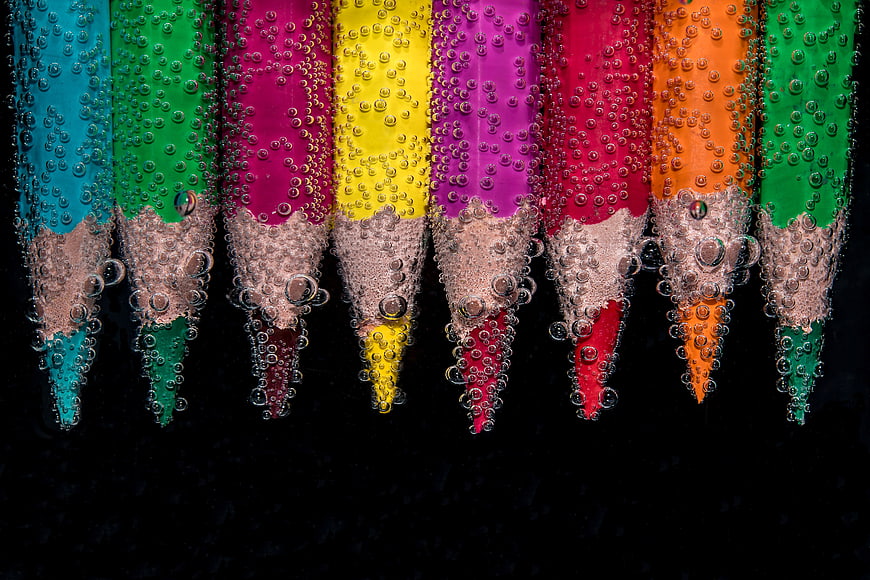 Colorful Pencils Submerged in Water with Bubbles