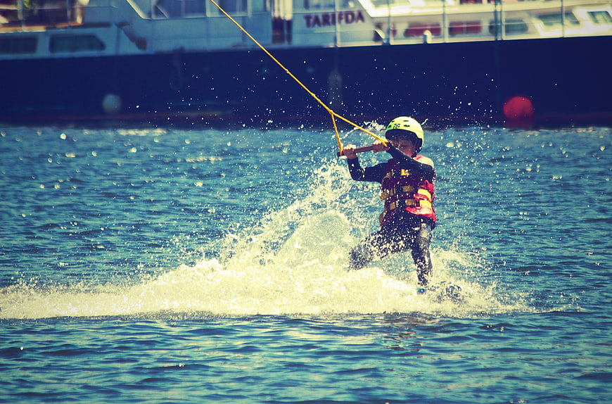 Action shot of a person water skiing on a lake