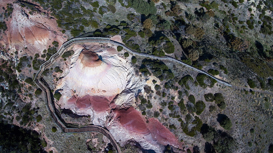 Aerial view of volcanic crater with wooden boardwalk