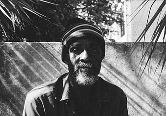 Black and white portrait of man in beanie with shadows