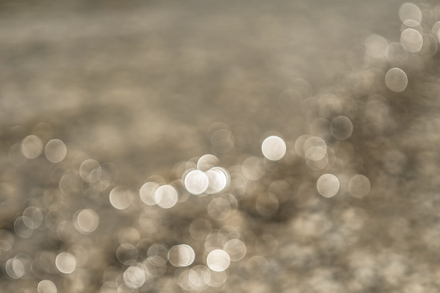 Abstract beige bokeh background with soft light circles