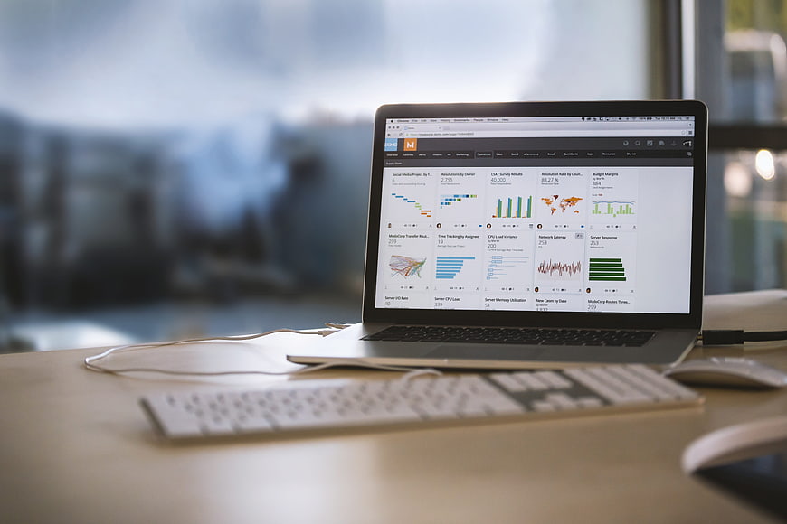 Laptop displaying business analytics dashboard on office desk