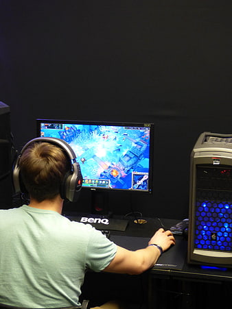 Gamer Playing Strategy Game On Benq Monitor In Dark Room