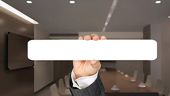Businessman Holding Blank White Card In Modern Conference Room
