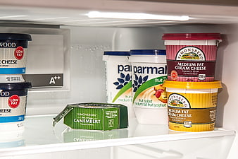 Dairy products and cheese inside a refrigerator shelf