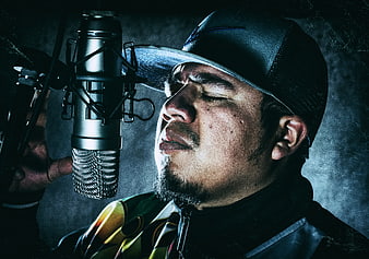 Male Rapper Singing Passionately into Studio Microphone