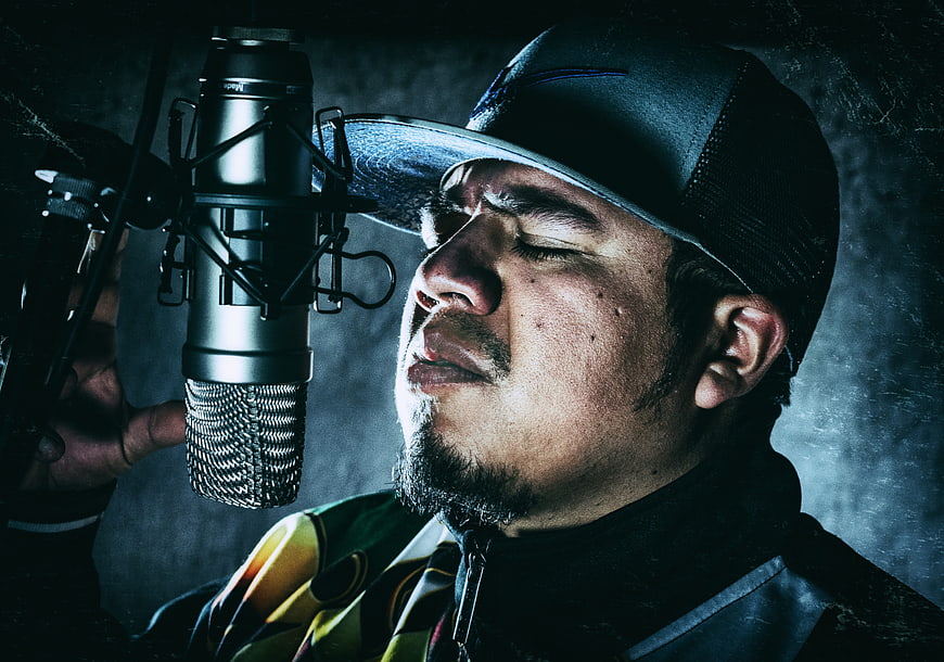 Male Rapper Singing Passionately into Studio Microphone