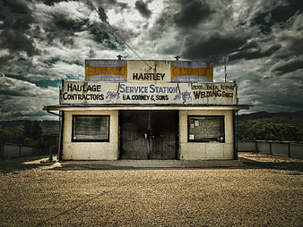 Vintage Service Station Under Dramatic Stormy Sky
