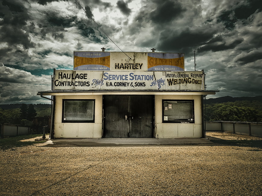 Vintage Service Station Under Dramatic Stormy Sky