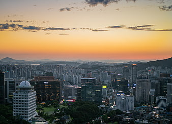 Seoul Cityscape at Sunset with Skyscrapers and Mountains