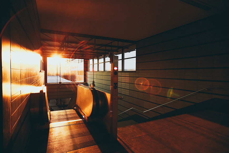 Sunlit Empty Escalator in Urban Station Interior