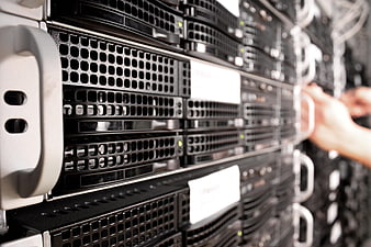 Close-up of server rack with technician hands