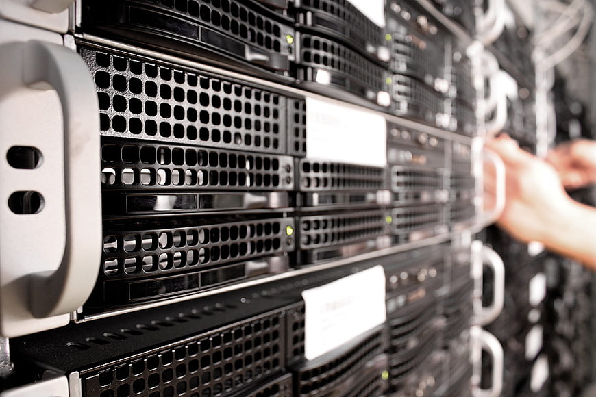 Close-up of server rack with technician hands