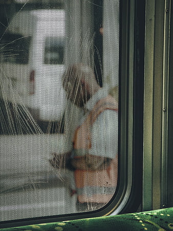 Blurred View of People Through Train Window Mesh