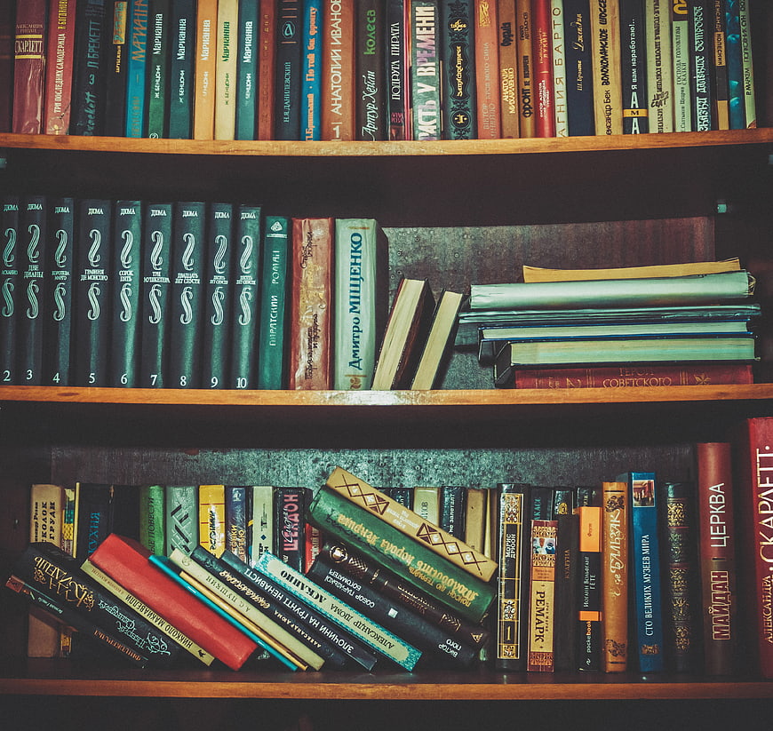 Vintage Bookshelf with Russian Literature and Old Books