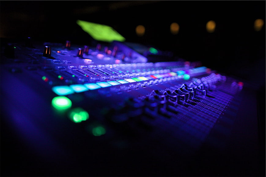 Illuminated Audio Mixing Console in Dark Studio
