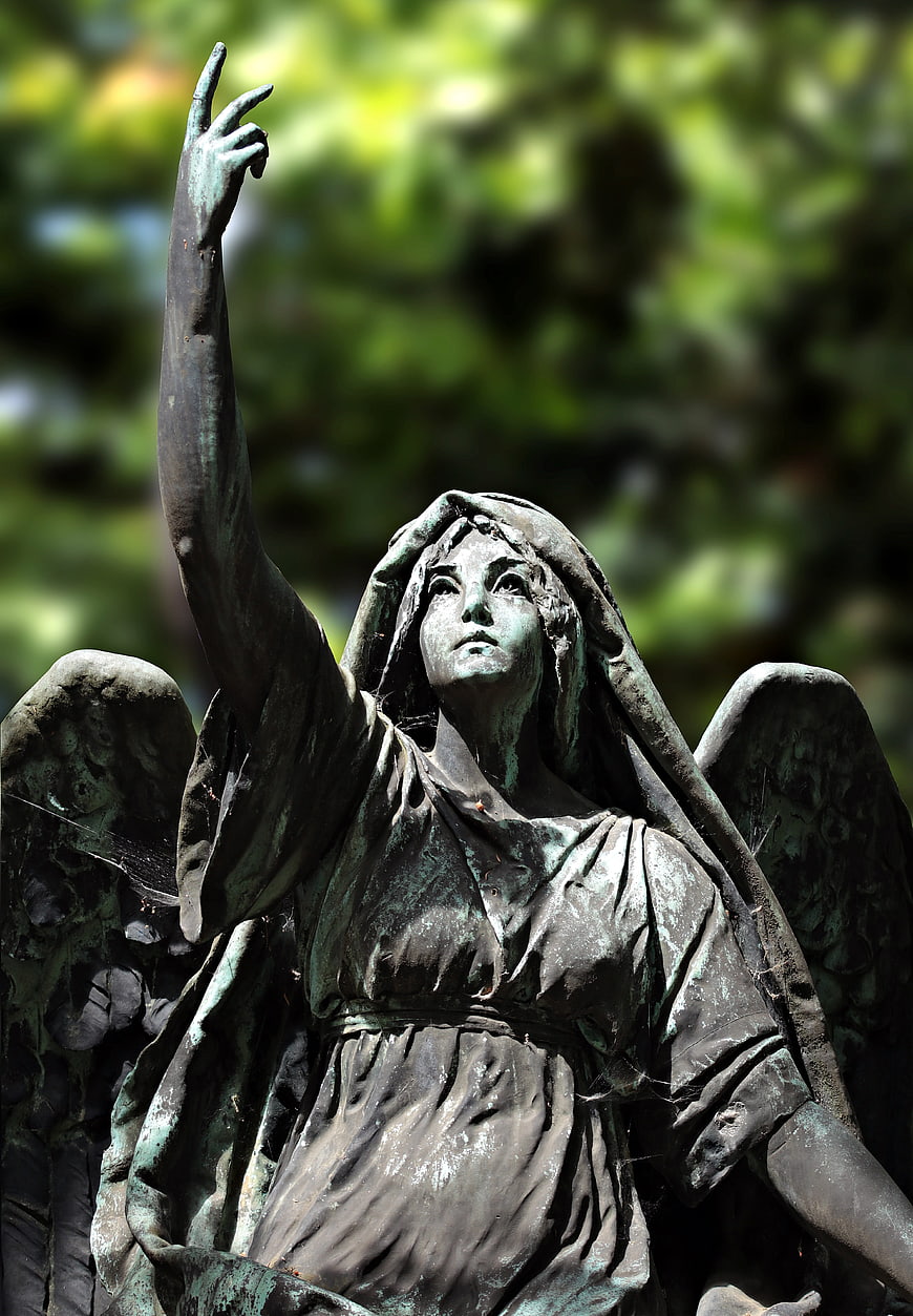 Bronze Angel Statue with Raised Hand in Park