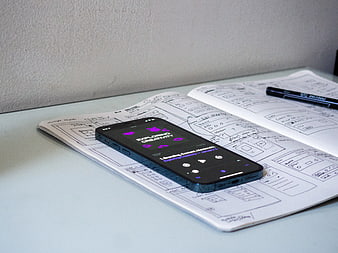 Smartphone with Podcast App on Sketchbook with Wireframes